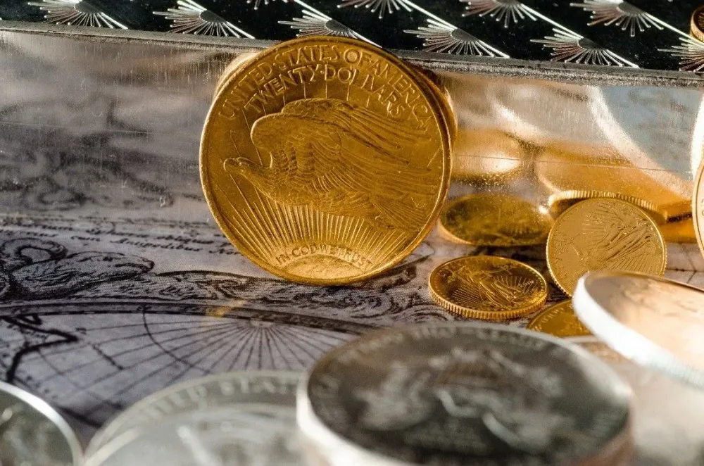 Gold firms, silver gains as traders weigh Hormuz risk, dollar firmness